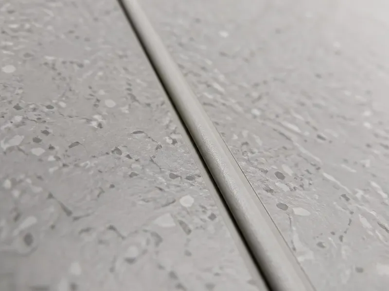 Heat-welded seam detail in healthcare sheet vinyl flooring, weld rod set into the routed groove